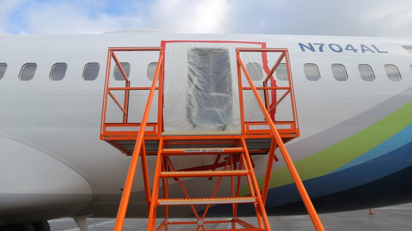 plastic covers the exterior of the fuselage plug area of Alaska Airlines Flight 1282 Boeing 737-9 MAX