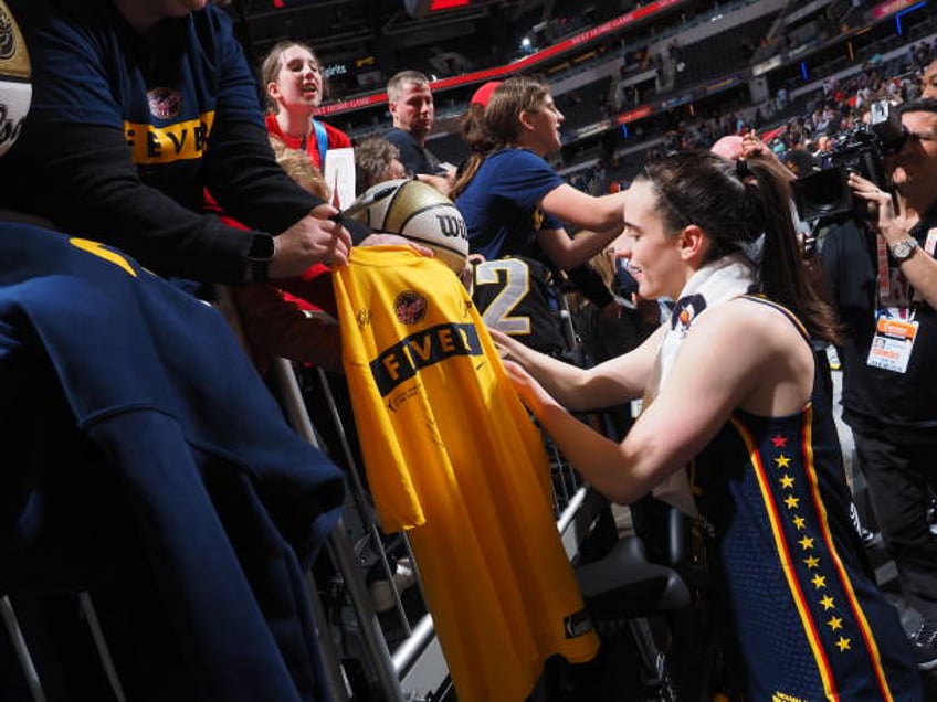 Caitlin Clark of the Indiana Fever autographs after the game against the Atlanta Dream on May 9, 2024 at Gainbridge Fieldhouse in Indianapolis,...