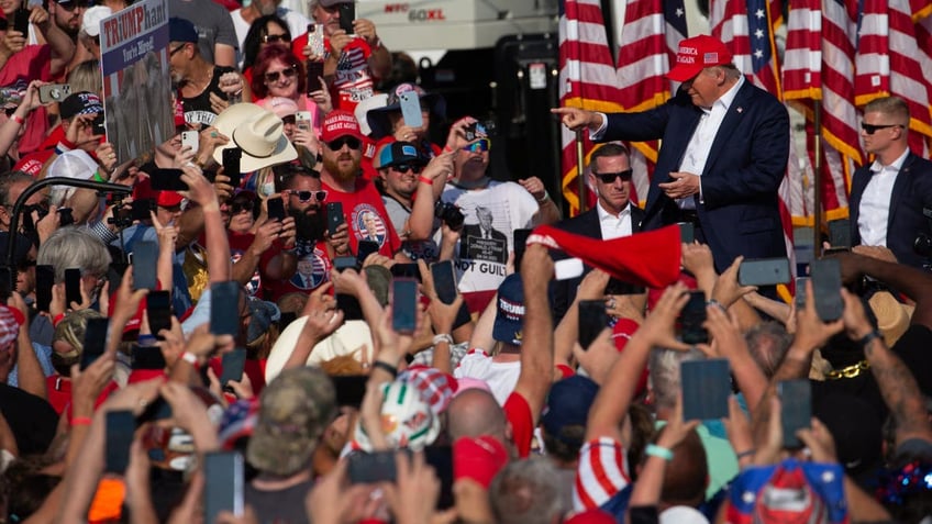 Former President Donald Trump greets the crowd as he arrives at a campaign event in Butler, Pennsylvania, July 13, 2024.