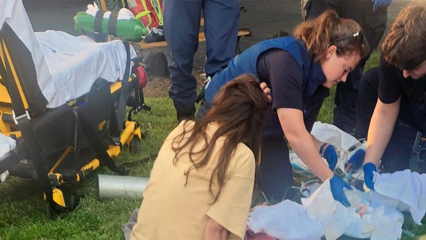 priest jumps into action to help woman deliver twin babies outside cathedral surreal