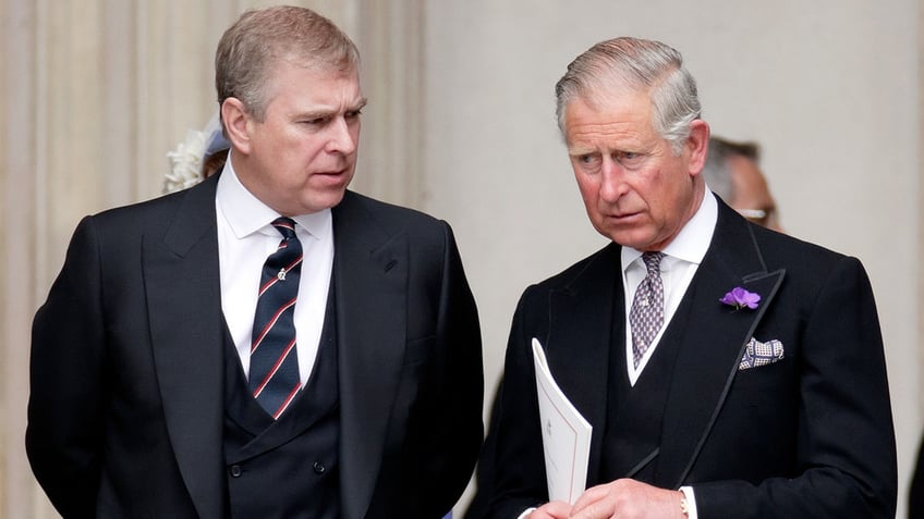 King Charles listening to Prince Andrew speak.