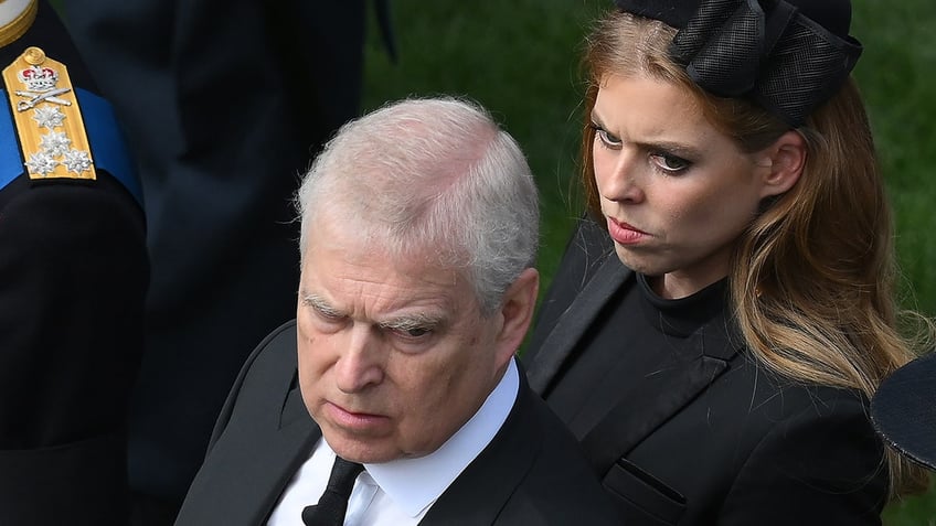 Princess Beatrice wearing all black looking at her father.