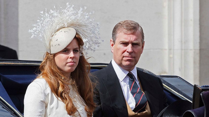 Princess Beatrice sitting next to her father, Prince Andrew, in a royal carriage as they both look serious.