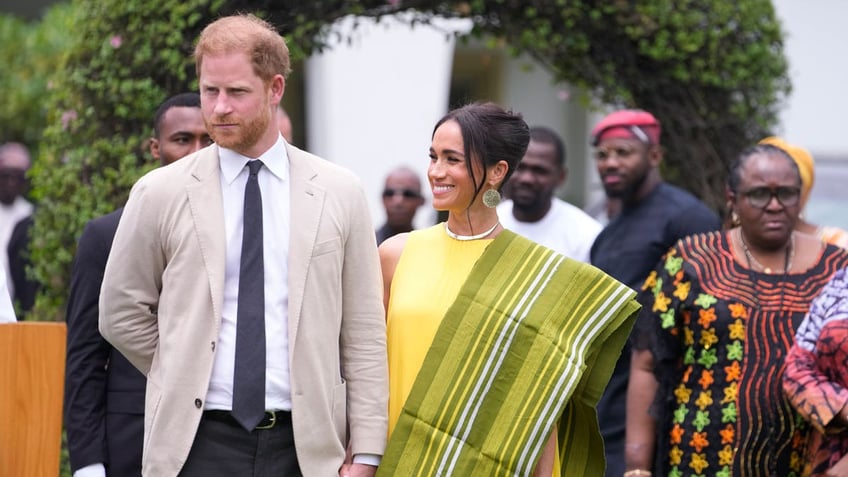 prince harry and meghan markle experience nigerian dancing fashion while visiting charities