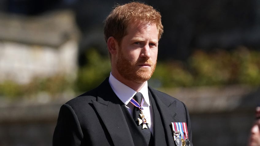 Prince Harry in a black suit at Prince Phillips funeral