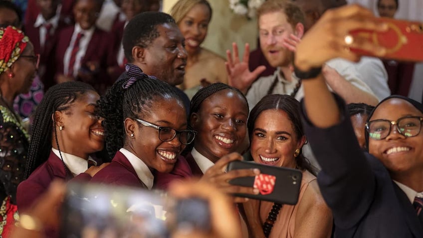 Prince Harry and Meghan are feted in a school in Nigeria