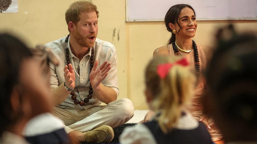 Prince Harry and Meghan are feted in a school in Nigeria