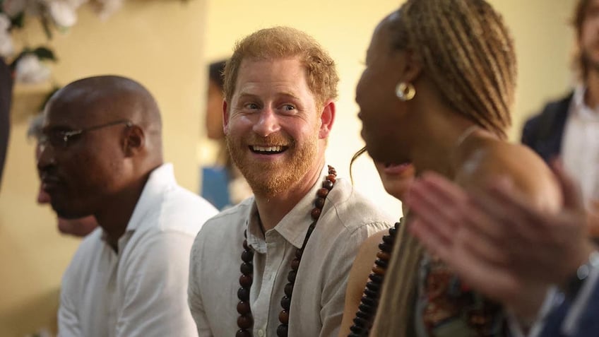 Prince Harry and Meghan are feted in a school in Nigeria