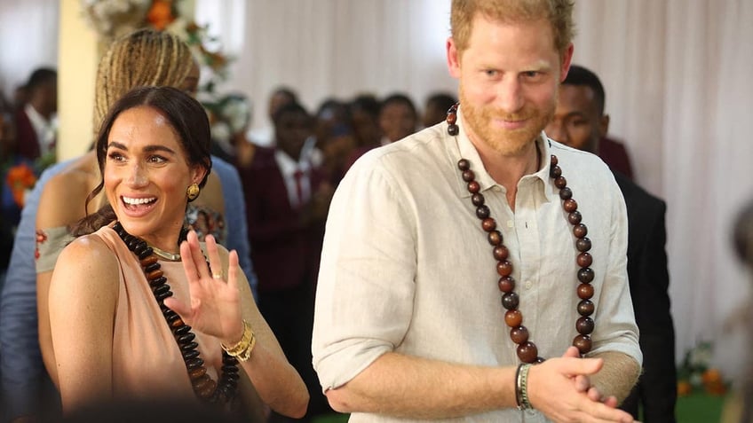 Prince Harry and Meghan are feted in a school in Nigeria