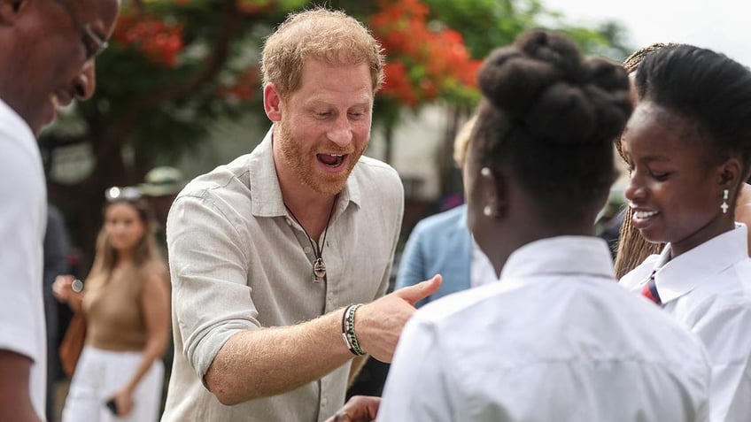 Prince Harry and Meghan are feted in a school in Nigeria