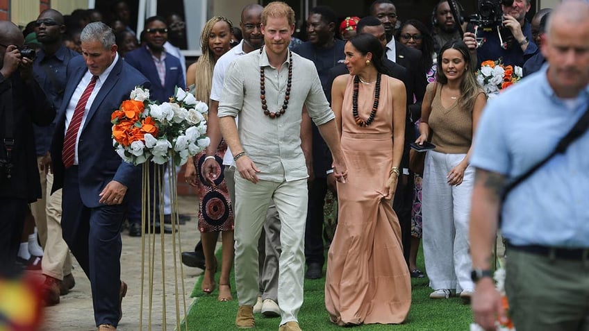 Prince Harry and Meghan are feted in a school in Nigeria