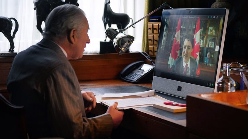 King Charles looking in front of a computer