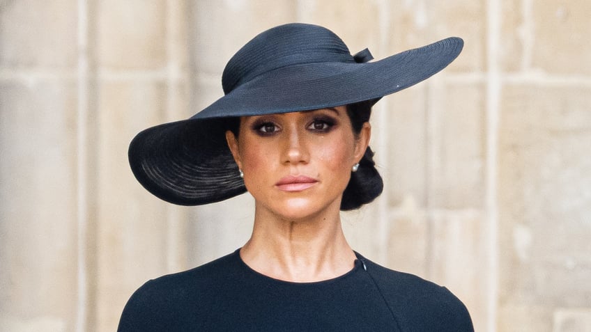 Meghan Markle wears a black dress and a black hat at Queen Elizabeth's funeral.