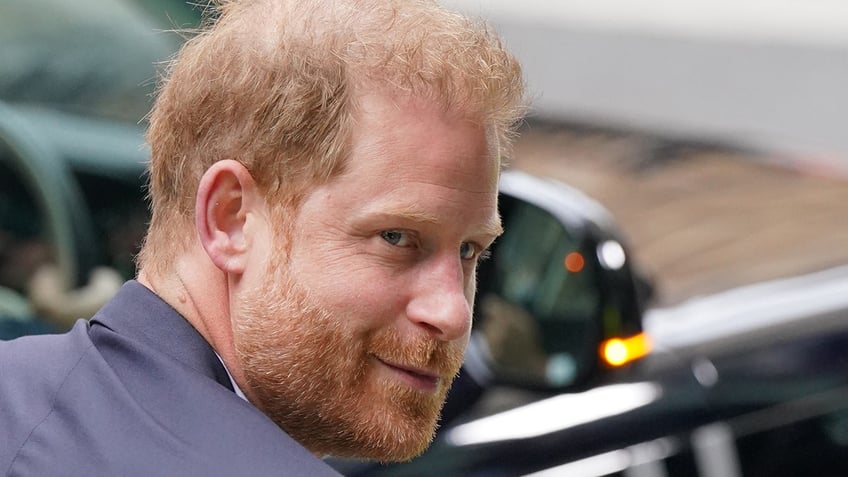 A close-up of Prince Harry smirking