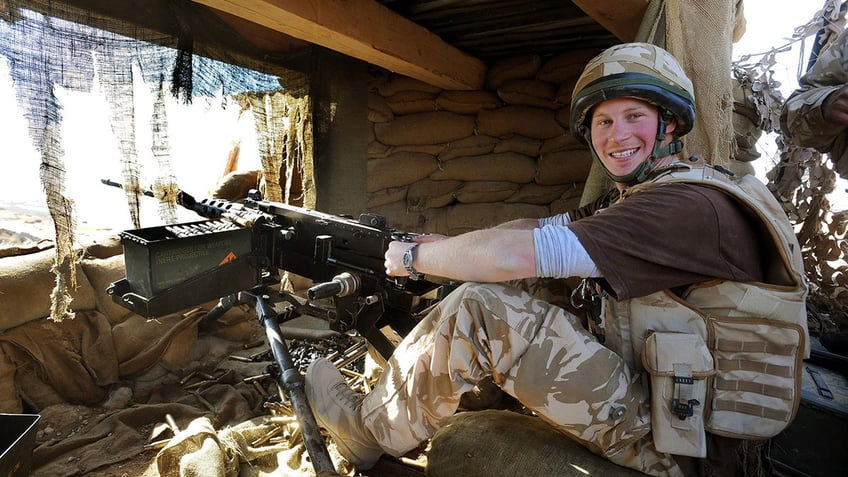 Prince Harry smiling in military gear.