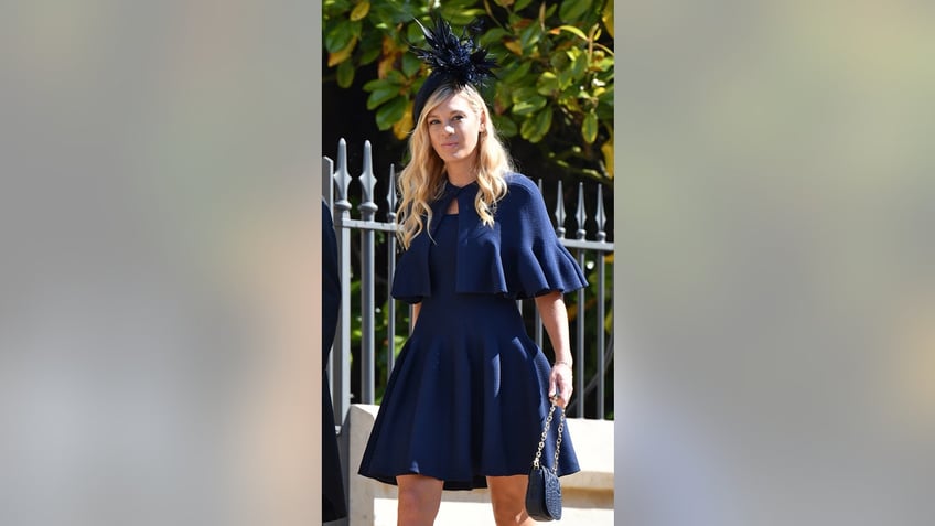 Chelsy Davy wearing a blue dress and matching fascinator