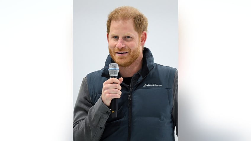 Prince Harry holding a mic