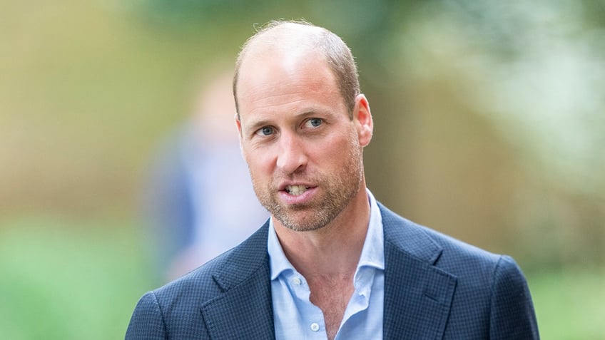 A close-up of Prince William with a beard.