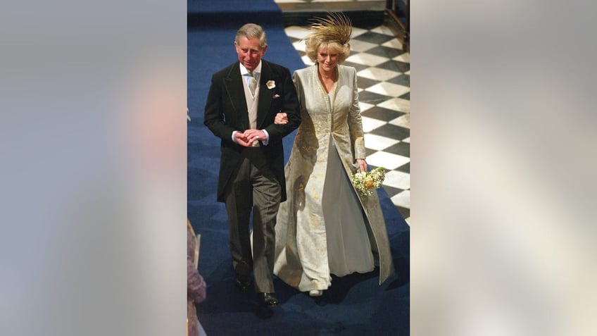 Queen Camilla and King Charles walking down the aisle on their wedding day.