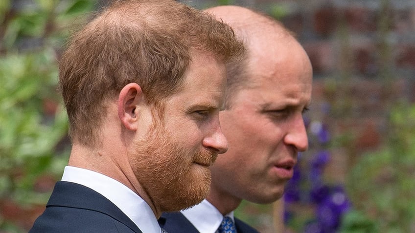 Prince Harry and Prince William looking to the side.