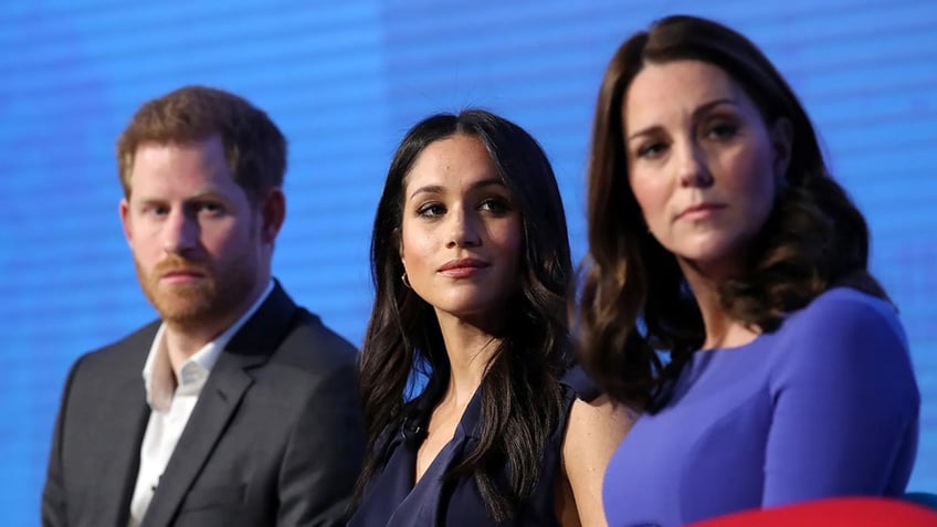 Prince Harry, Meghan Markle and Kate Middleton sitting in a row and looking serious