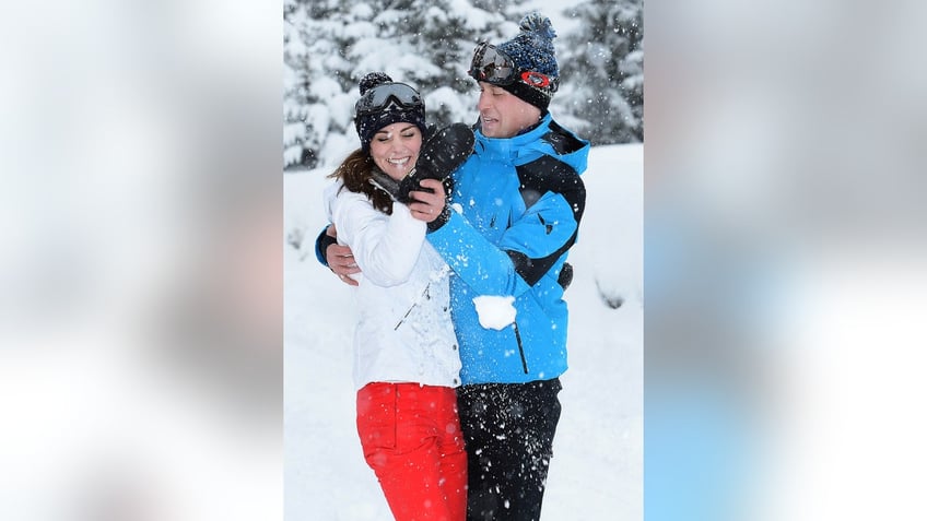 Prince William and Kate Middleton playing in the snow.