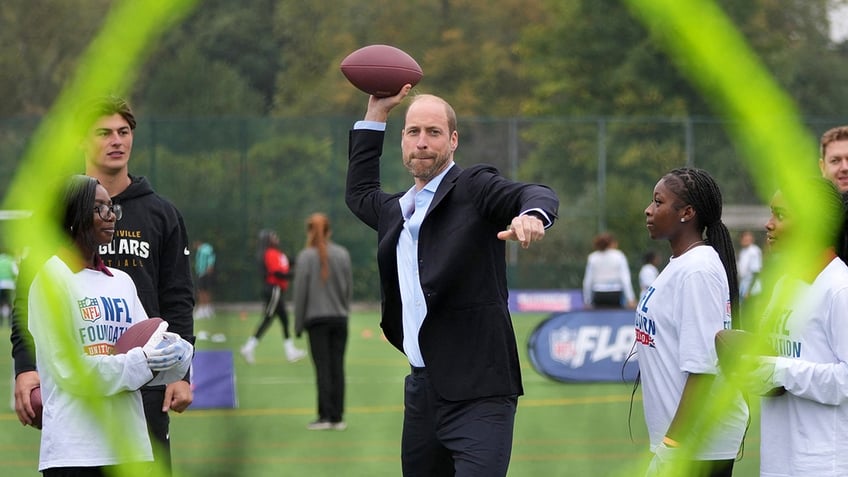 Prince William throwing a football.