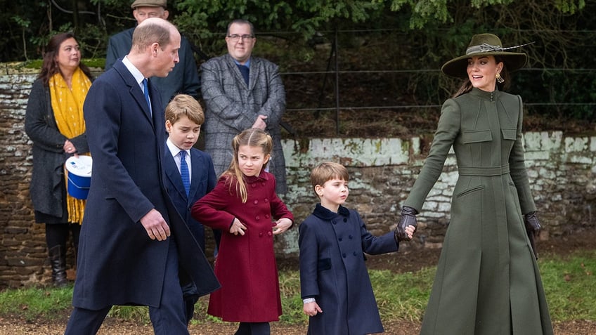 The British royal family dressed up in formal wear and walking in a row.