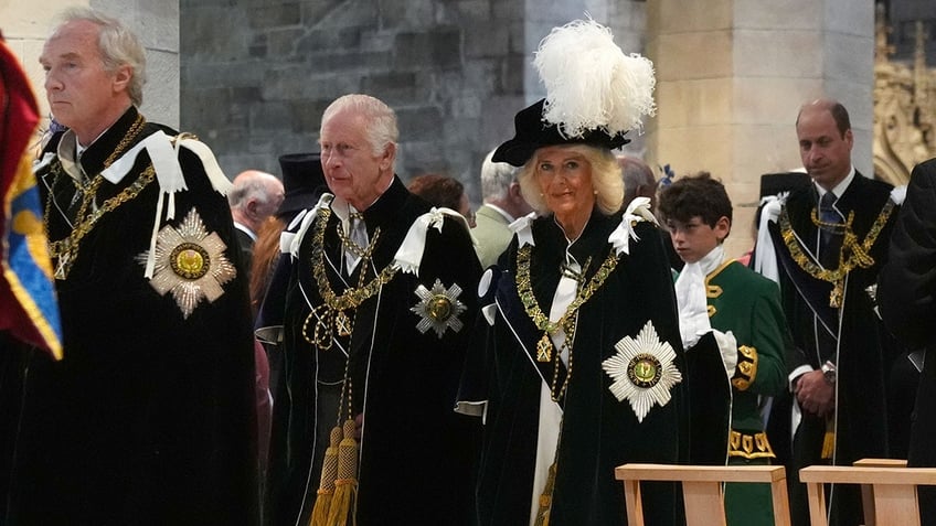King Charles III and Queen Camilla walking in church