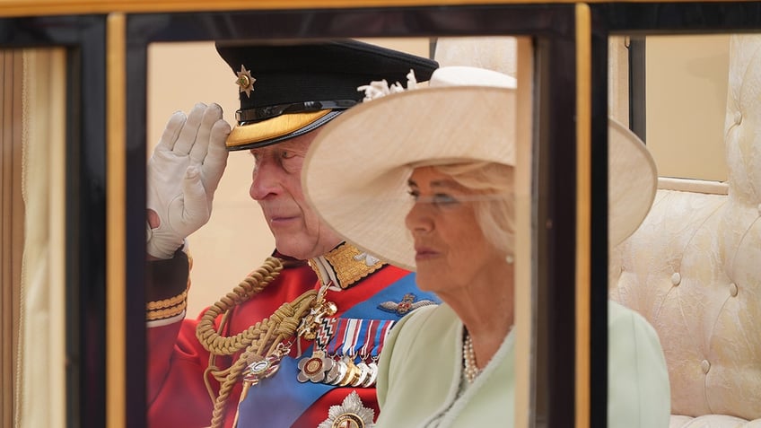 King Charles and Queen Camilla inside a royal carriage