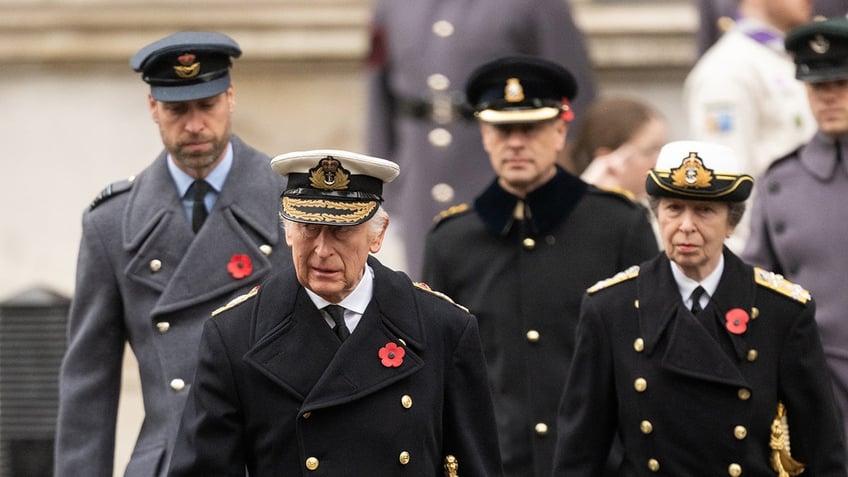 The British royals in military wear walking together.