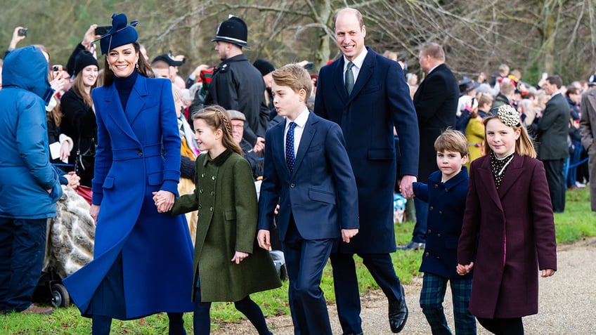 The Prince and Princess of Wales greeting the public with their children and other young relatives