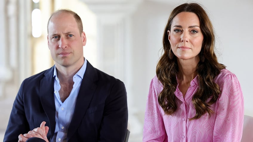 Prince William and Kate Middleton sitting next to each other and looking serious