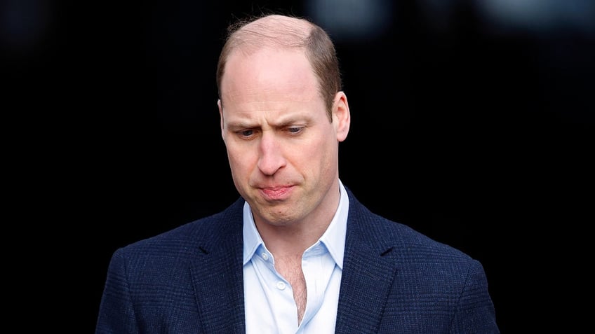 Prince William looking down at the floor serious