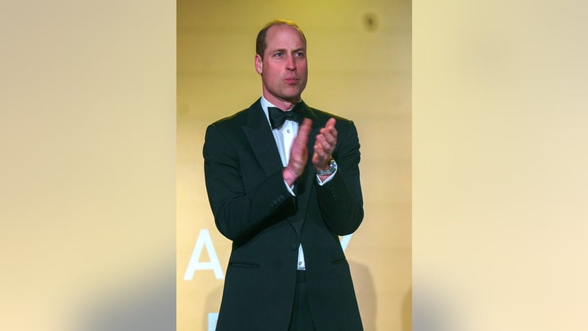 Prince William applauding in a tux.