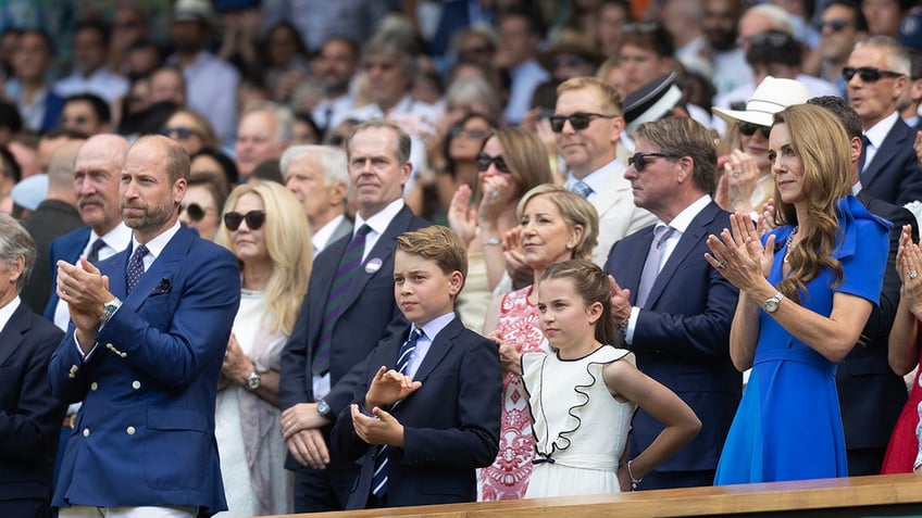 The Wales family applauding at Wimbledon.