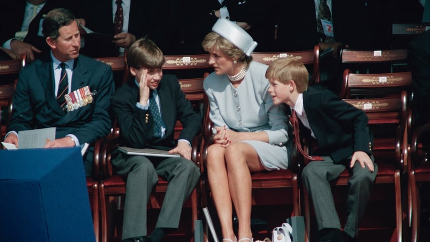 princess diana sitting with prince charles and young harry and william