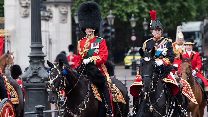 Princess Anne riding on horseback next to her brother Prince Edward.