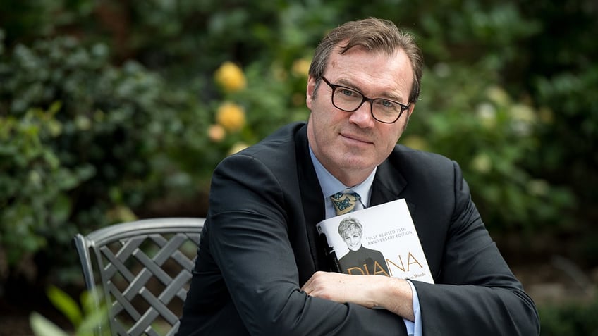 Andrew Morton holding a copy of his book