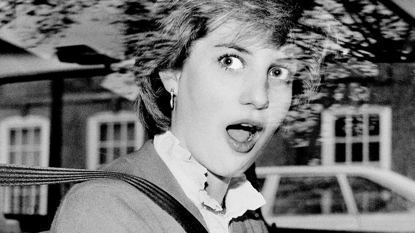 Princess Diana looking stunned inside her car.