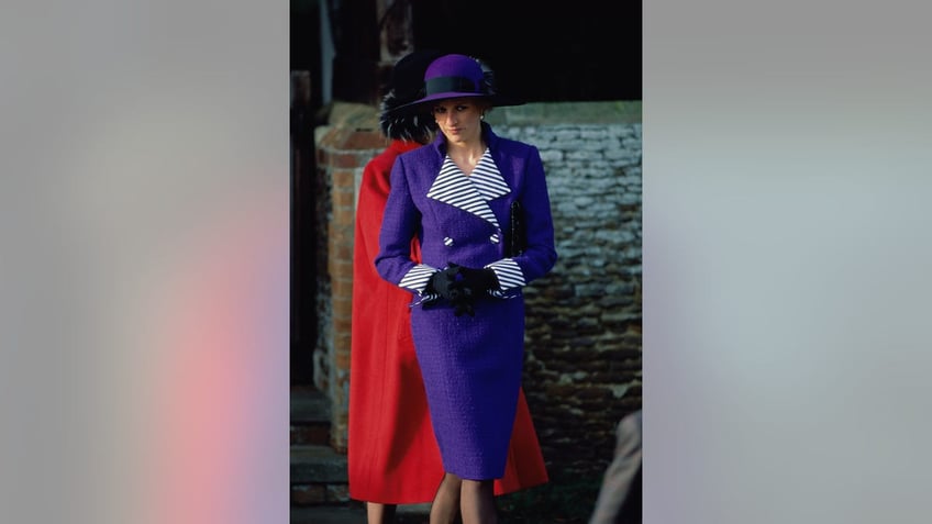 Princess Diana wearing a bright purple and stripe suit.