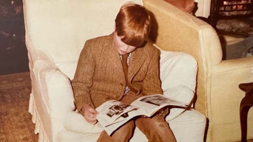 Charles Spencer reading a book