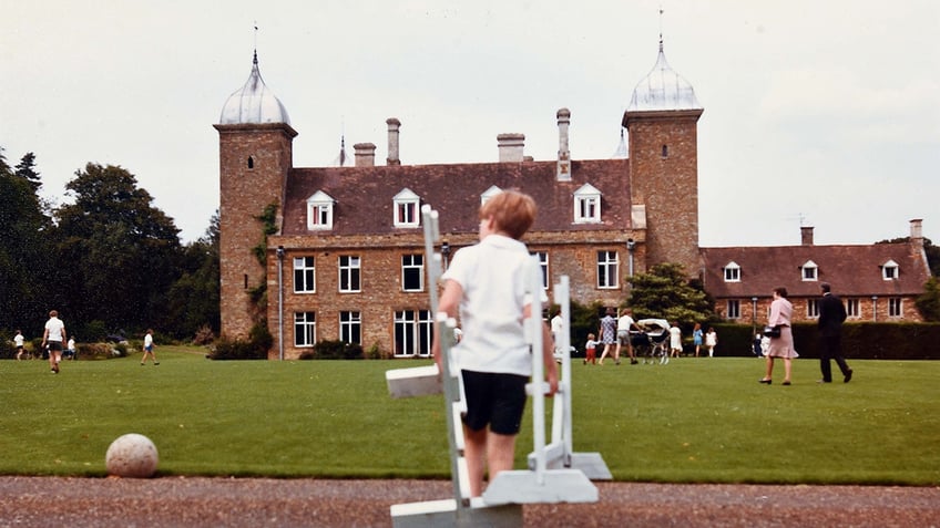 Charles Spencer standing in front of his boarding school