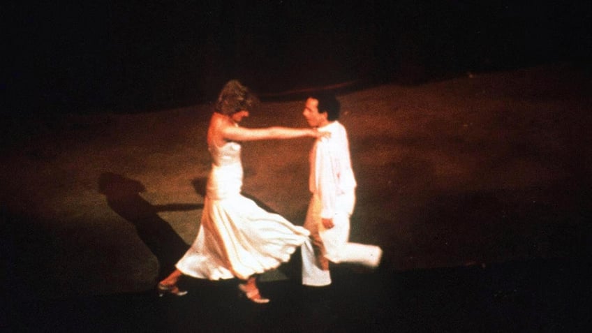 Princess Diana dancing with Wayne Sleep on stage.