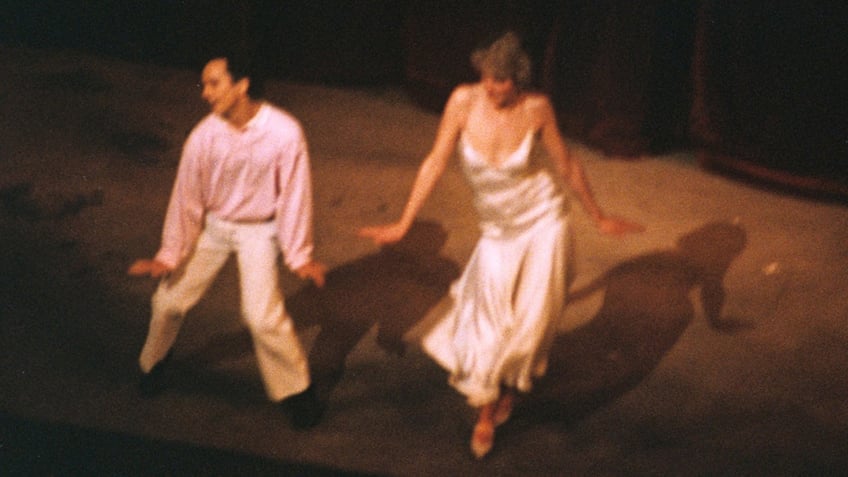 A close-up of Princess Diana dancing with Wayne Sleep on stage.