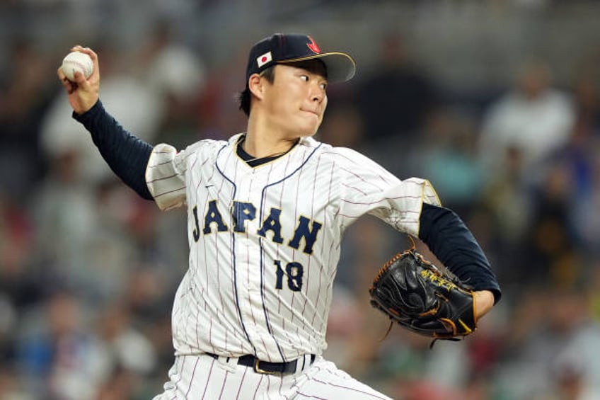 Yoshinobu Yamamoto of Team Japan pitches in the eighth inning against Team Mexico during the World Baseball Classic Semifinals at loanDepot park on...