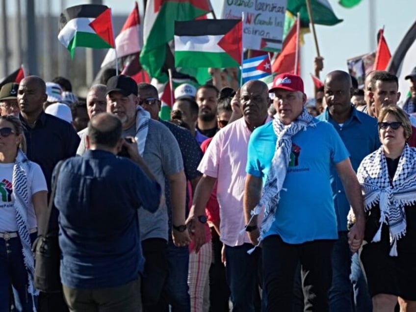 Cuban President Miguel Díaz-Canel, center, and his wife Lis Cuesta march during a pro-Pal