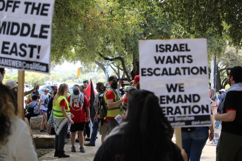 Anti-Israel protesters carry signs condeming Israel's response to October 7 Hamas attack, Photo by Randy Clark Breitbart Texas