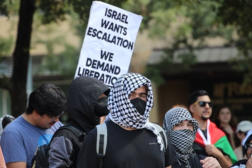 Heavily masked protesters listen to speaker at Austin Pro-Hamas protest, photo by Randy Clark Breitbart Texas.