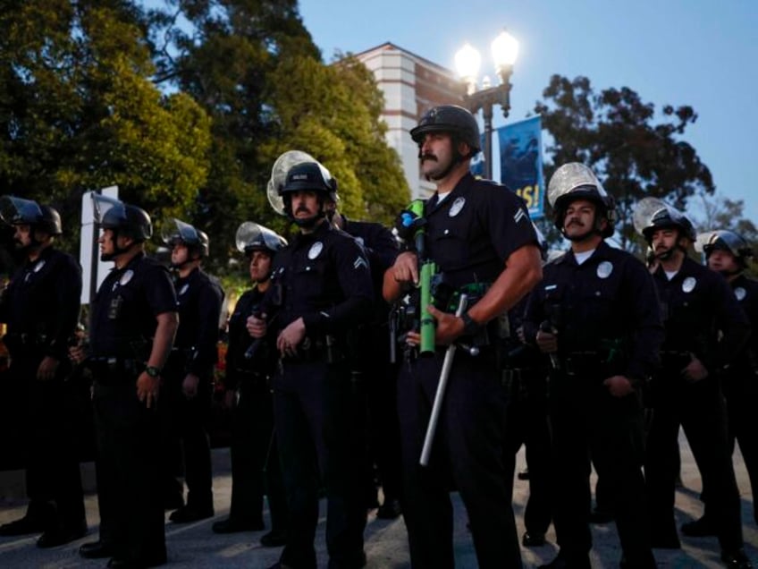 Police officers get into position as pro-Palestinian students and activists demonstrate on